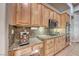 Kitchen counter features stainless steel appliances, granite counters, and light wood cabinetry at 2064 Poetry Ave, Henderson, NV 89052