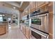 Close-up of stainless steel ovens in modern kitchen with tile flooring and granite countertops at 2064 Poetry Ave, Henderson, NV 89052