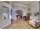 Elegant open-concept living area featuring a piano, chandelier, and hardwood flooring at 2064 Poetry Ave, Henderson, NV 89052