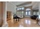 Elegant living room with hardwood floors, piano and high ceilings at 2064 Poetry Ave, Henderson, NV 89052