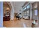 Bright and airy living room with hardwood floors, a piano, and modern decor at 2064 Poetry Ave, Henderson, NV 89052