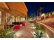 Covered patio with seating area and red beanbag chairs at 2064 Poetry Ave, Henderson, NV 89052