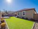 Artificial turf lawn with a view of home's exterior and entertainment area at 2242 Valdina St, Henderson, NV 89044