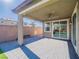 Covered patio with ceiling fan and sliding glass doors opening to a grassy backyard at 2242 Valdina St, Henderson, NV 89044