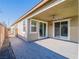 Covered patio with ceiling fan, sliding glass doors, and gray brick pavers at 2242 Valdina St, Henderson, NV 89044