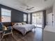 Main bedroom with a king-size bed, dark accent wall, and wood flooring at 2242 Valdina St, Henderson, NV 89044