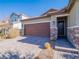 Front view of a house with a brown garage door and stone accents at 2242 Valdina St, Henderson, NV 89044