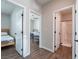 Hallway with doors to bedrooms and bathroom, featuring wood flooring at 2242 Valdina St, Henderson, NV 89044