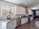 Modern kitchen featuring white cabinets, gray countertops, and stainless steel appliances at 2242 Valdina St, Henderson, NV 89044