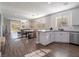 Open concept kitchen with white cabinets, island, and hardwood floors at 2242 Valdina St, Henderson, NV 89044