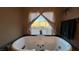 Relaxing bathroom with a large jetted tub and backyard view at 2316 Mountain Rail Dr, North Las Vegas, NV 89084