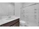 Well-lit bathroom showcasing a shower with glass doors, white countertops, dark cabinets, and a mirror at 2430 Bellinzona Pl, Henderson, NV 89044