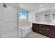 Modern bathroom with a shower, tub, double vanity, and bright natural light at 2430 Bellinzona Pl, Henderson, NV 89044