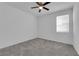 Neutral bedroom featuring a ceiling fan, a carpeted floor, a window, and white walls at 2430 Bellinzona Pl, Henderson, NV 89044