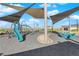 Modern playground with a shade structure, slide, and climbing equipment at 2430 Bellinzona Pl, Henderson, NV 89044