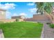 Landscaped backyard with grassy lawn and brick border at 2598 Iron Crest Ln, Las Vegas, NV 89138