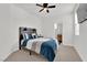 Bedroom with a wooden bed frame and ceiling fan at 2598 Iron Crest Ln, Las Vegas, NV 89138