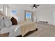 Main bedroom with a king-size bed, a large window with mountain views, and a ceiling fan at 2598 Iron Crest Ln, Las Vegas, NV 89138