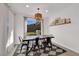 Bright dining room with rustic table, metal chairs, and backyard view at 2598 Iron Crest Ln, Las Vegas, NV 89138