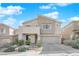 Two-story house with stone accents and landscaped front yard at 2598 Iron Crest Ln, Las Vegas, NV 89138