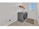 Laundry room features a washer, dryer, and built-in shelving at 2598 Iron Crest Ln, Las Vegas, NV 89138