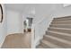 Modern staircase with a light-colored carpet runner at 2598 Iron Crest Ln, Las Vegas, NV 89138