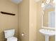 Small bathroom with pedestal sink, toilet, and mirror at 3020 Via Venezia, Henderson, NV 89052