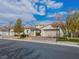 Two-story home with a three car garage, landscaping and a large driveway at 3020 Via Venezia, Henderson, NV 89052