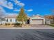 Single-story home with tan siding, neutral colored garage door, and well-manicured landscaping at 3020 Via Venezia, Henderson, NV 89052