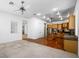 Open kitchen with wood cabinets, hardwood floors and island, visible from living room at 3020 Via Venezia, Henderson, NV 89052