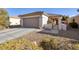 Charming single-story home with a two-car garage and a desert-landscaped front yard at 3025 Seaford Peak Dr, Henderson, NV 89052