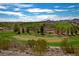 Scenic view of the golf course with players, lush green fairways, and distant mountain views at 3025 Seaford Peak Dr, Henderson, NV 89052