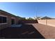 Landscaped backyard with gravel and block wall at 304 Whitney Breeze Ave, North Las Vegas, NV 89031