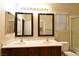 Double vanity bathroom with large mirrors and updated lighting at 304 Whitney Breeze Ave, North Las Vegas, NV 89031