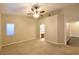 Primary bedroom with ceiling fan, large window and ensuite bathroom at 304 Whitney Breeze Ave, North Las Vegas, NV 89031