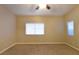 Spacious bedroom with ceiling fan, neutral walls, and carpet flooring at 304 Whitney Breeze Ave, North Las Vegas, NV 89031