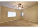 Bright and airy bedroom with ceiling fan and neutral carpeting at 304 Whitney Breeze Ave, North Las Vegas, NV 89031