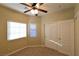 Bright bedroom with two windows and a ceiling fan at 304 Whitney Breeze Ave, North Las Vegas, NV 89031