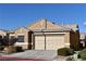 Tan one-story house with a two-car garage and desert landscaping at 304 Whitney Breeze Ave, North Las Vegas, NV 89031