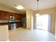 Kitchen with stainless steel appliances and wood cabinets at 304 Whitney Breeze Ave, North Las Vegas, NV 89031