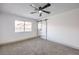 Spacious bedroom with ceiling fan and sliding barn door at 3425 Irv Marcus Dr, Las Vegas, NV 89108