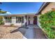 Front entryway with red door and stone pathway at 3425 Irv Marcus Dr, Las Vegas, NV 89108