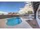 Refreshing kidney-shaped pool, surrounded by patio at 3425 Irv Marcus Dr, Las Vegas, NV 89108