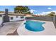 Stunning kidney-shaped pool in a large backyard at 3425 Irv Marcus Dr, Las Vegas, NV 89108