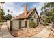 View of the side of the house with a brick chimney and a gate to a backyard at 3988 Salisbury Pl, Las Vegas, NV 89121