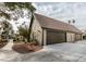 Exterior view of a brown double garage with a paved driveway and walkway at 3988 Salisbury Pl, Las Vegas, NV 89121