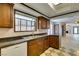 Kitchen with granite countertops, wood cabinets, and a view of the living room at 3988 Salisbury Pl, Las Vegas, NV 89121