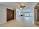 Bright living room featuring hardwood floors, a ceiling fan, and double doors at 3988 Salisbury Pl, Las Vegas, NV 89121