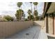 Private patio with block wall and view of trees at 3988 Salisbury Pl, Las Vegas, NV 89121