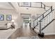 Elegant two-story entryway with a grand staircase and wood-look tile floor at 4063 Villa Rafael Dr, Las Vegas, NV 89141